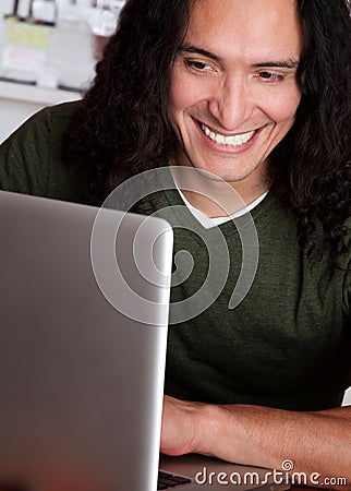 Smiling Native American Man Working on a Laptop Stock Photo