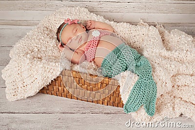 Smiling Newborn Baby Girl in a Mermaid Costume Stock Photo