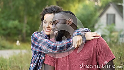 Smiling newly married couple celebrate buying new cottage in countryside Stock Photo