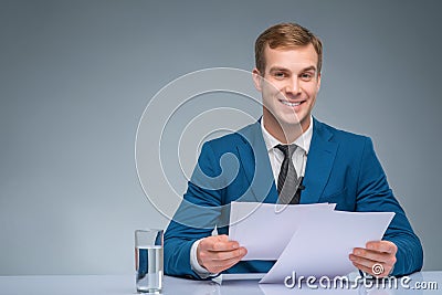 Smiling newscaster during broadcasting Stock Photo