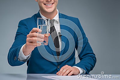 Smiling newsman holding a glass of water Stock Photo