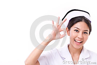 Smiling nurse making ok hand gesture Stock Photo