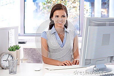 Smiling office worker using computer Stock Photo