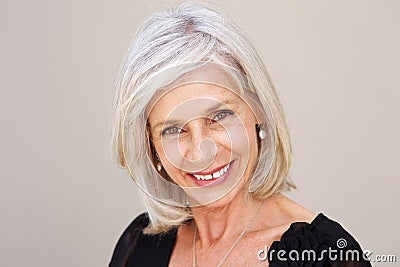 Smiling older woman looking happy in black blouse Stock Photo