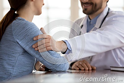 Smiling optimistic doctor greeting patient with complete recovery Stock Photo