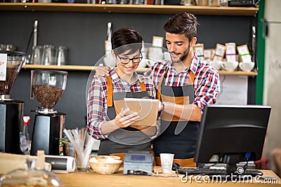 Smiling owners taking order Stock Photo