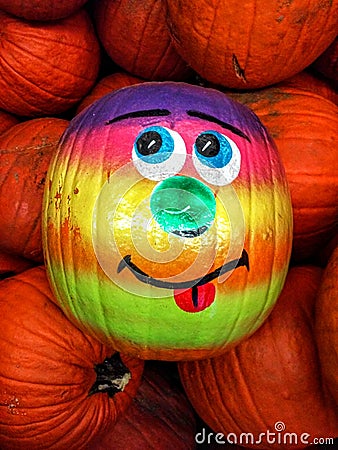 Smiling Painted Pumpkin In A Group Of Pumpkins Stock Photo