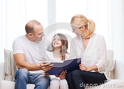 Smiling parents and little girl with at home Stock Photo