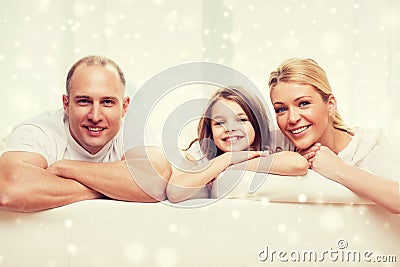 Smiling parents and little girl at home Stock Photo