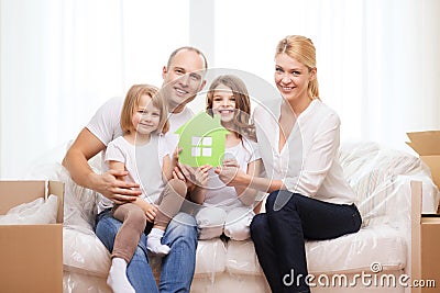 Smiling parents and two little girls at new home Stock Photo