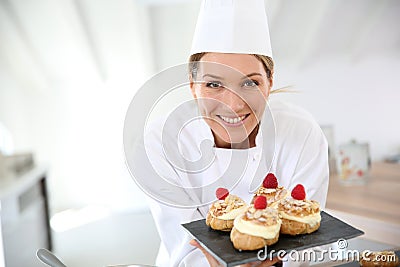 Smiling pastry chef with deserts Stock Photo