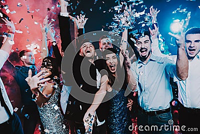 Smiling People Celebrating New Year on Party. Stock Photo