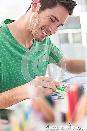 Smiling photo editor working on a contact sheet Stock Photo