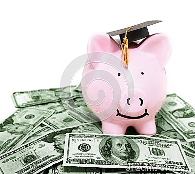 Smiling piggy bank with graduation cap Stock Photo