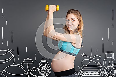 Smiling pleasant pregnant woman doing sport exercises Stock Photo