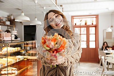 Smiling pleasant woman 20s in knitted sweater, showing beautiful Stock Photo
