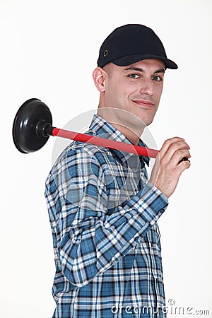 Smiling plumber holding plunger Stock Photo