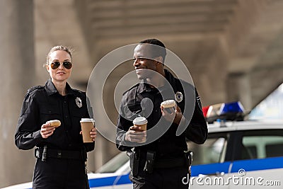 smiling police officers having coffee break Stock Photo