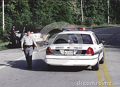 Smiling police offiecr at the scene of a traffic accident in Beltsville, Maryland Editorial Stock Photo