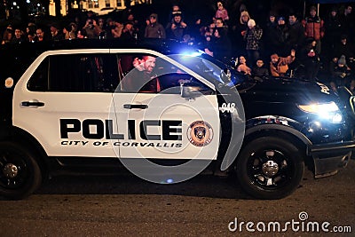 Smiling policeman waves at camera from police car in parade Editorial Stock Photo