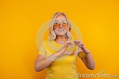 Smiling positive lady showing heart getsure isolated. Stock Photo