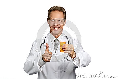 Smiling practitioner showing thumb up gesture. Stock Photo