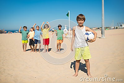 Smiling preteen boy posing with soccer ball Stock Photo