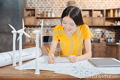 Smiling pretty engineer finishing her amazing scheme Stock Photo