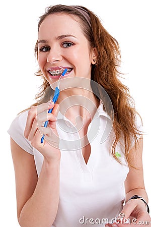 Smiling pretty girl wearing braces and holding a b Stock Photo