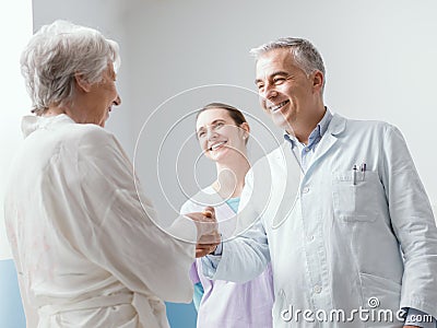 Doctor and nurse meeting a senior patient at the hospital Stock Photo