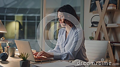 Smiling programmer finish work on computer at night office satisfied closeup. Stock Photo