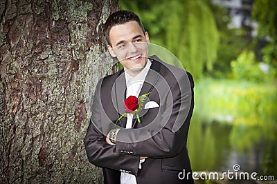 Smiling proud groom - young male in suit Stock Photo