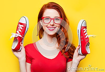 Smiling redhead girl with gumshoes Stock Photo