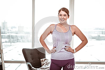 Smiling resolute young woman wearing comfortable light clothes Stock Photo