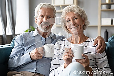 Smiling retired family spouses enjoying lazy weekend morning time. Stock Photo