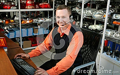 Smiling Salesman Auto Parts Store Stock Photo