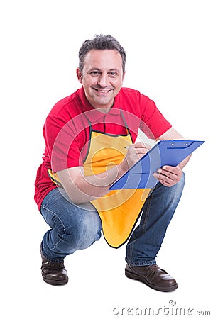 Smiling salesman counting products on supermarket shelf Stock Photo