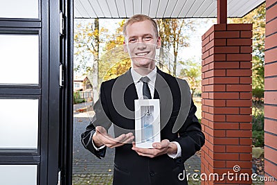 Smiling salesman selling perfume Stock Photo