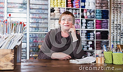 Smiling saleswoman is working at table Stock Photo