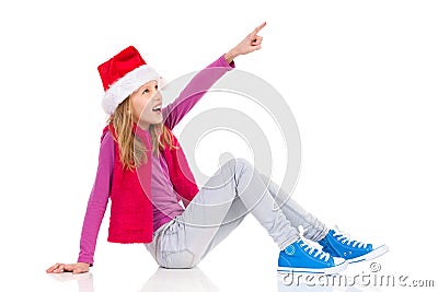 Smiling Santa Little Girl Pointing Stock Photo