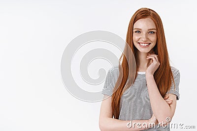 Smiling sassy good-looking ginger european young 20s girl student amused entertained touch neck looking intrigued gazing Stock Photo