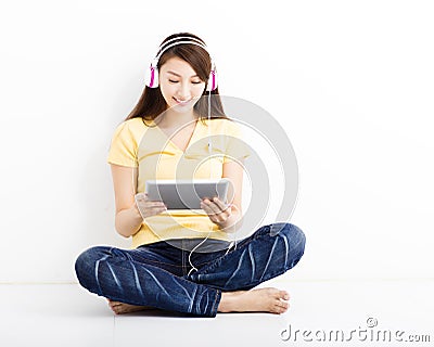 Smiling seated young woman with tablet pc Stock Photo