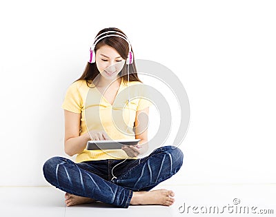 Smiling seated young woman with tablet pc Stock Photo