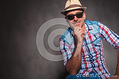 Smiling senior casual man wearing sunglasses and summer hat Stock Photo
