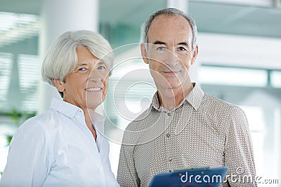 Smiling senior couple before house meeting Stock Photo