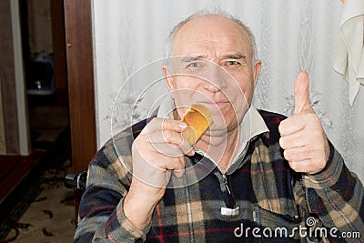 Smiling senior man giving a thumbs up Stock Photo