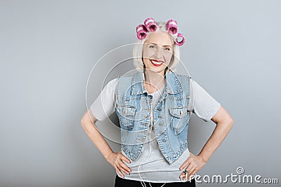 Smiling senior pleasant woman using headphones. Stock Photo