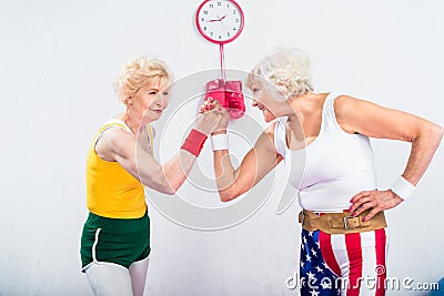 smiling senior sportswomen wrestling and looking at each other Stock Photo