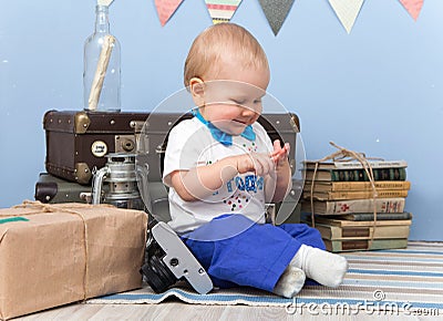 Smiling sitting little boy counts his fingers at home Stock Photo