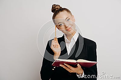 Female office worker writing down business ideas Stock Photo